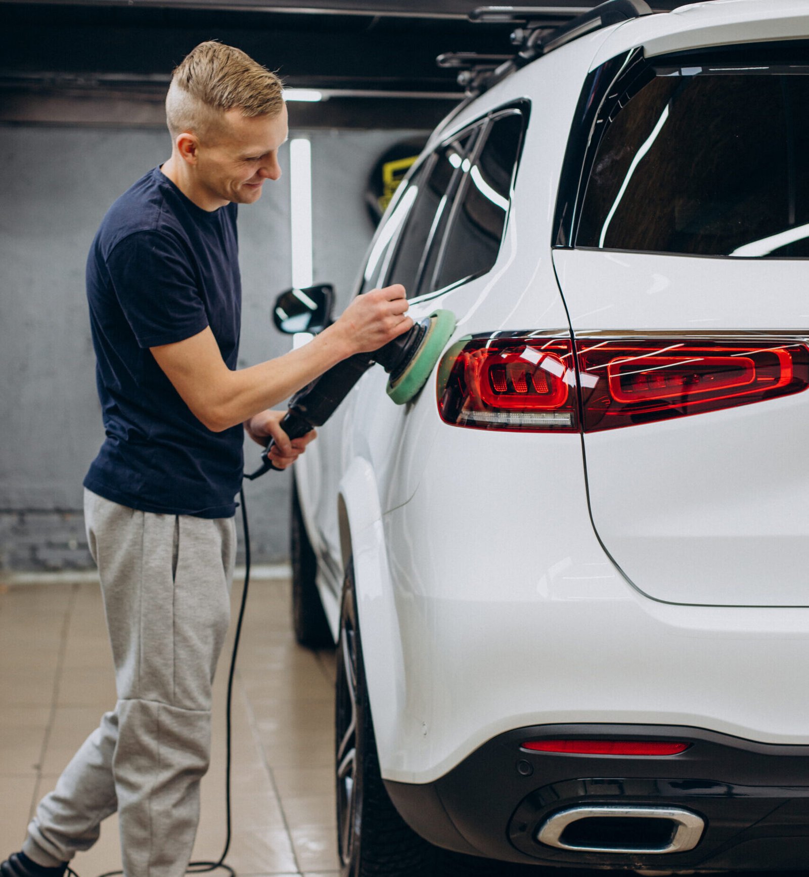Man polishing car with orbital applicator